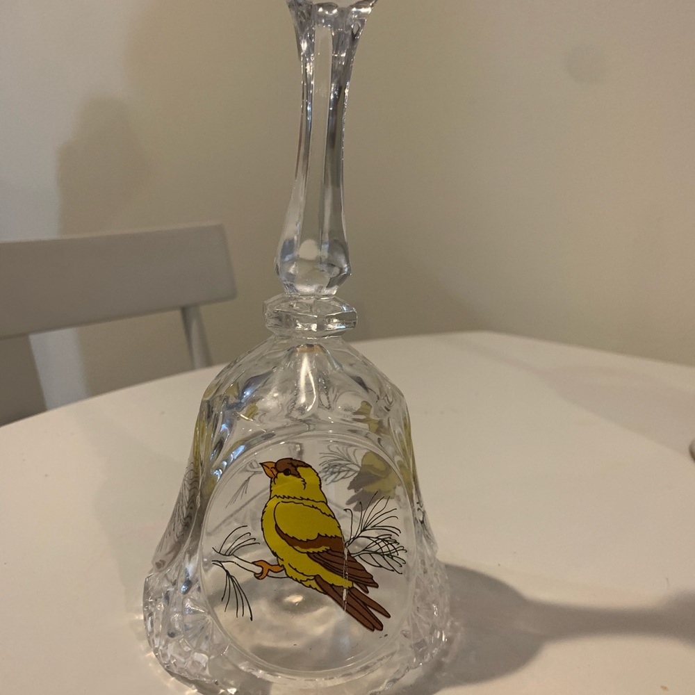 Glass bell with yellow bird
